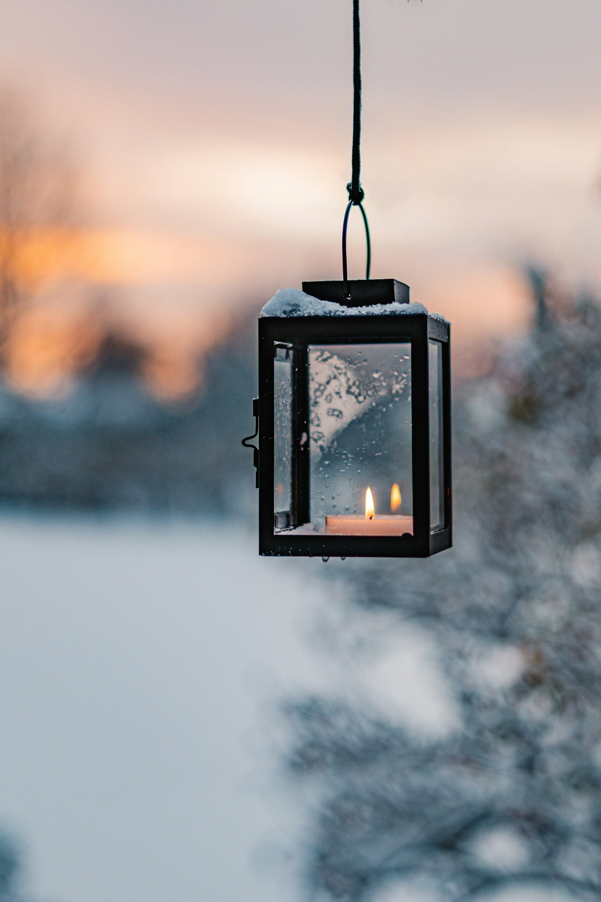 Candle lantern glowing warmly in a dim setting