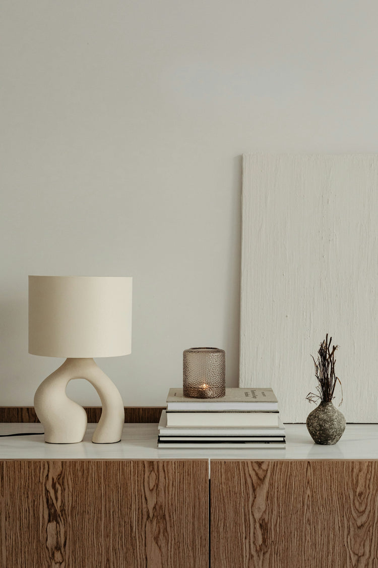 Warm sculptural table lamp in a neutral interior