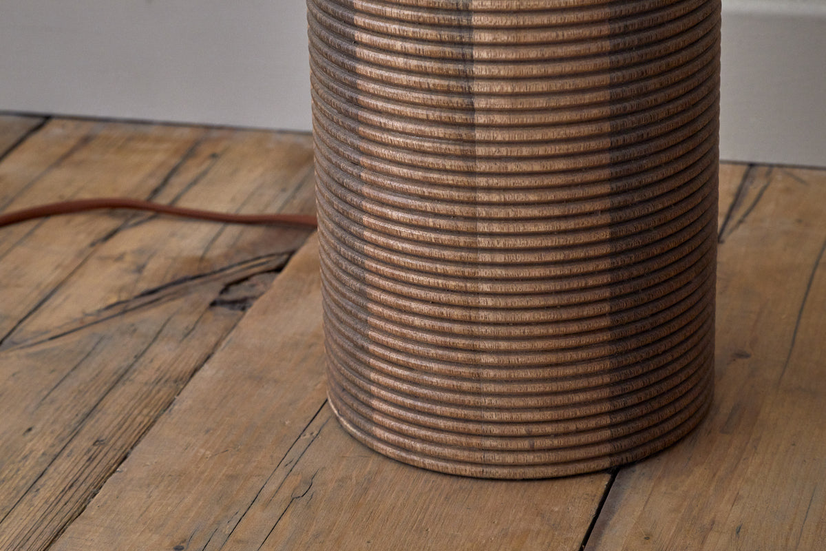 Close view of the grooved mango wood floor lamp base