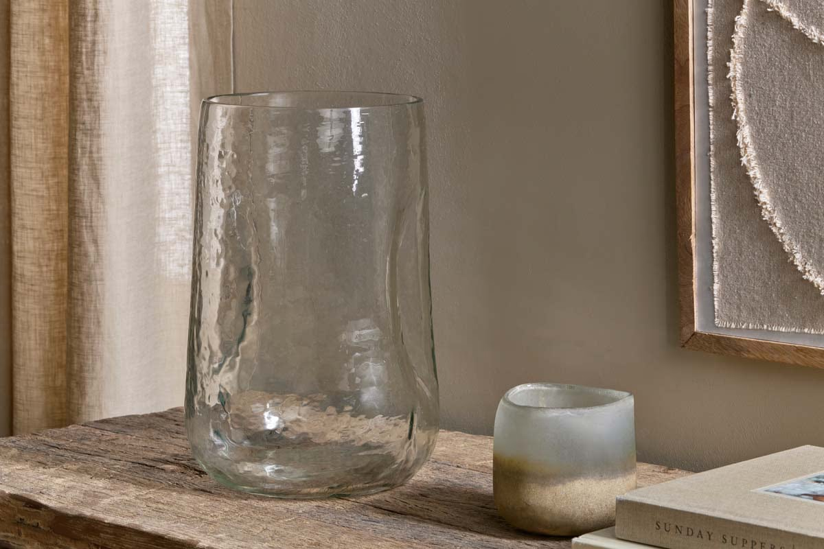 Clear organic recycled glass vase in a neutral interior