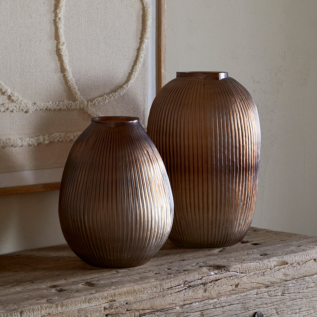Smoke brown ribbed recycled glass vases in a neutral interior