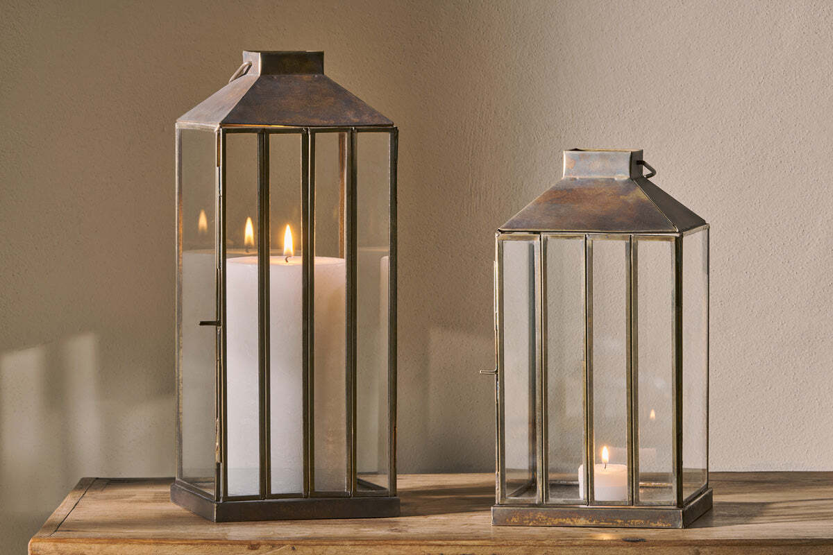 Aged antique candle lantern with glass panels